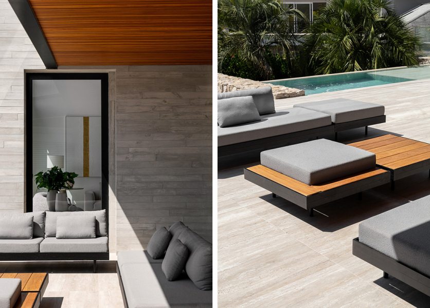 O mobiliário de linhas minimalistas, com tecidos cinza e bases metálicas pretas, complementa a estética contemporânea do projeto. Sofás e poltronas com tecidos específicos para áreas externas criam lounges de descanso junto à piscina, convidando ao convívio e ao relaxamento, enquanto o paisagismo discreto valoriza a leveza da arquitetura. A piscina, revestida com porcelanato Travertino Navona (Roca Cerámica), se conecta visualmente ao piso da varanda, criando uma atmosfera contínua e luminosa.